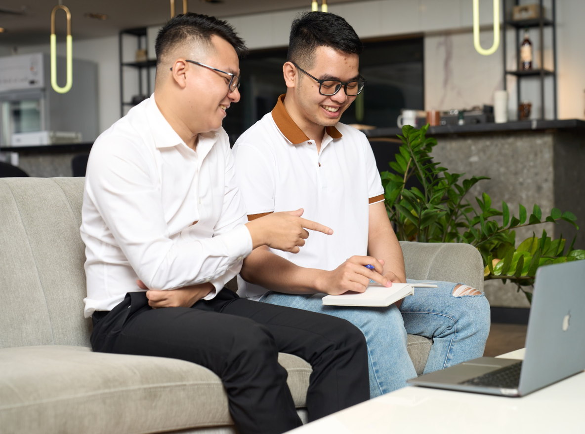 Careers-Learning and Development-2x two men working together with a notepad and laptop